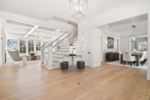 stairway with a chandelier, hardwood / wood-style flooring, coffered ceiling, crown molding, and beam ceiling