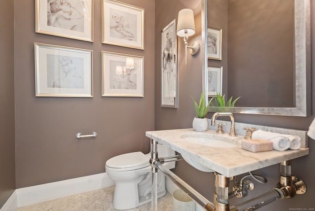 bathroom featuring tile patterned flooring, sink, and toilet