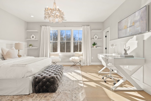 bedroom featuring a notable chandelier and light hardwood / wood-style flooring