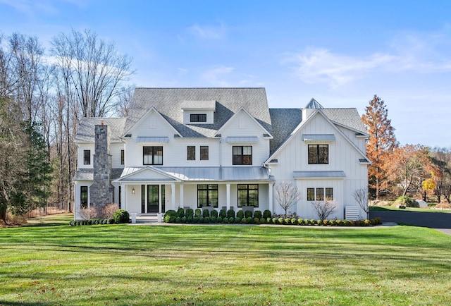 modern farmhouse style home featuring a front yard