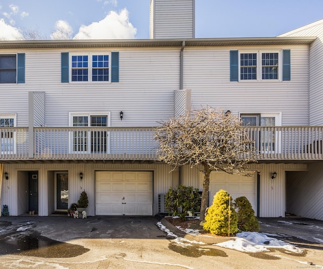 back of house featuring a garage