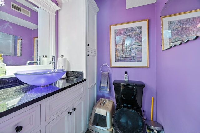 bathroom featuring vanity and toilet