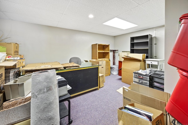 home office with a paneled ceiling and carpet flooring