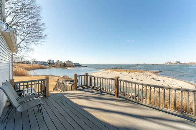 deck featuring a water view and a view of the beach