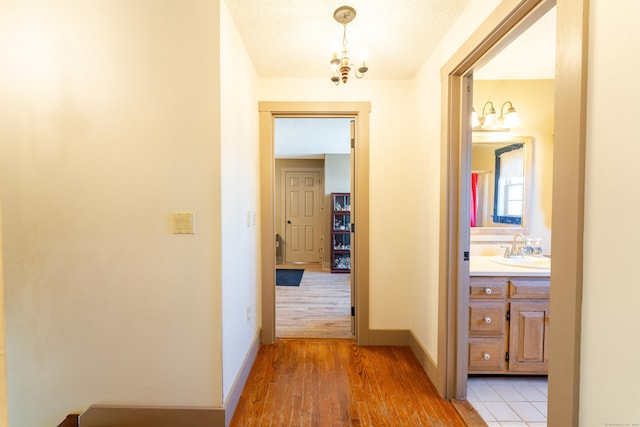 hall featuring sink and light hardwood / wood-style floors