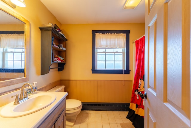 bathroom featuring a baseboard radiator, vanity, toilet, and tile patterned floors