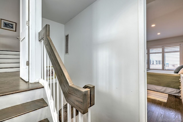 stairs featuring hardwood / wood-style floors