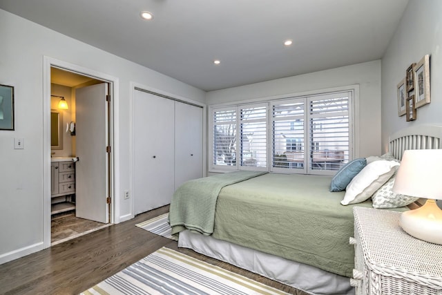 bedroom with dark hardwood / wood-style floors, ensuite bath, and a closet