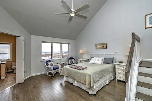 bedroom with high vaulted ceiling, dark hardwood / wood-style floors, ceiling fan, and ensuite bathroom