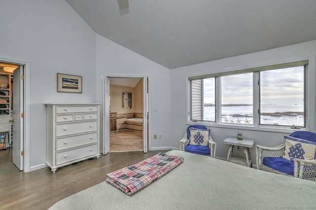 bedroom with dark hardwood / wood-style flooring, high vaulted ceiling, connected bathroom, and ceiling fan