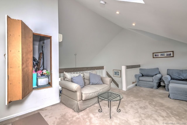 living room with light colored carpet, high vaulted ceiling, and a skylight