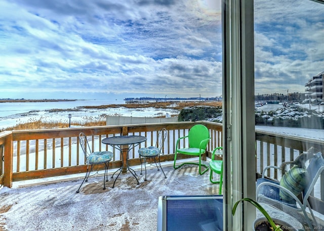 view of snow covered back of property