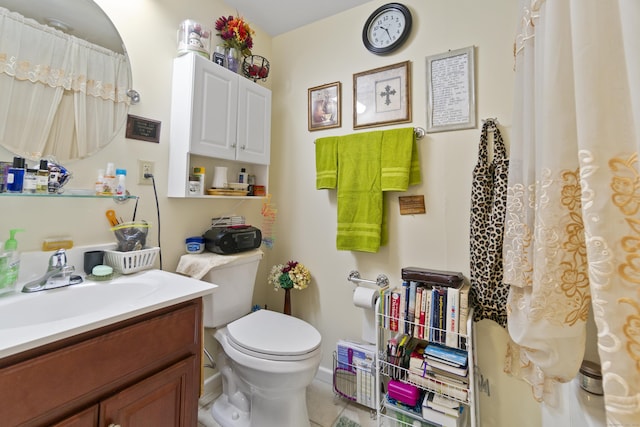 bathroom featuring tile patterned flooring, vanity, and toilet