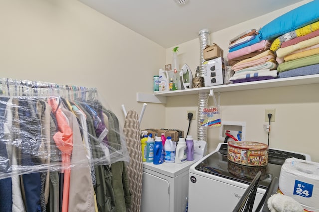 clothes washing area featuring separate washer and dryer