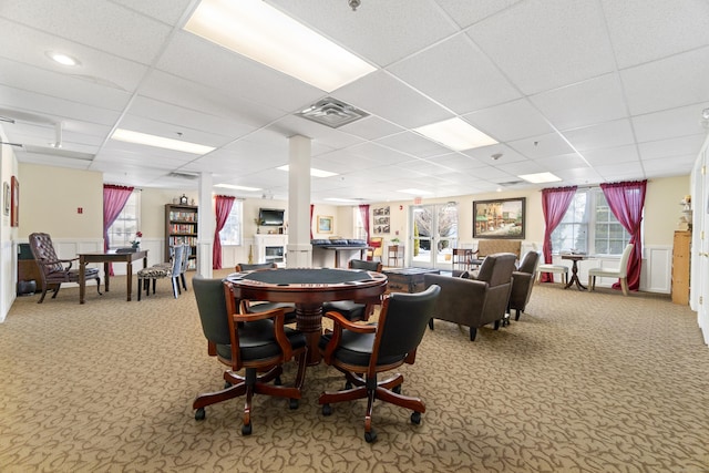 recreation room with carpet flooring and a paneled ceiling