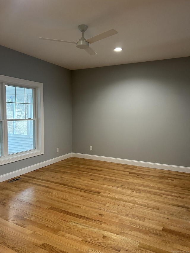 unfurnished room with ceiling fan and light wood-type flooring