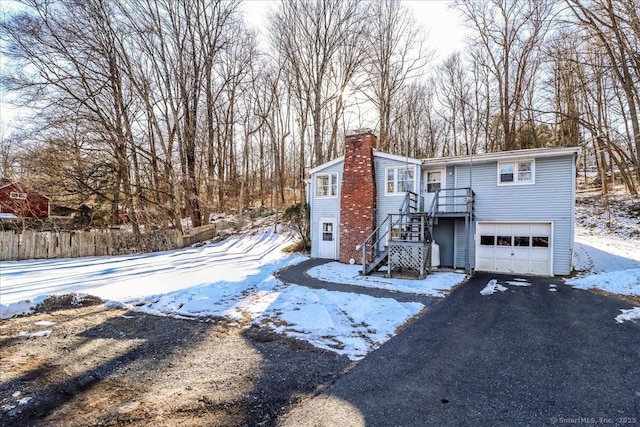 snow covered house with a garage