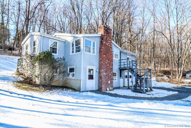 snow covered property featuring a deck