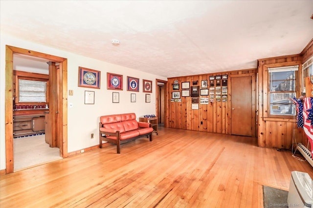 sitting room featuring wood-type flooring and wood walls