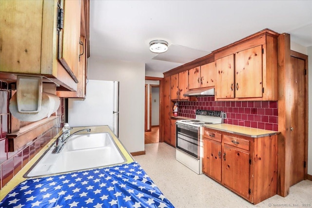 kitchen featuring tasteful backsplash, sink, and white appliances