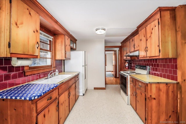 kitchen featuring sink, white appliances, and decorative backsplash