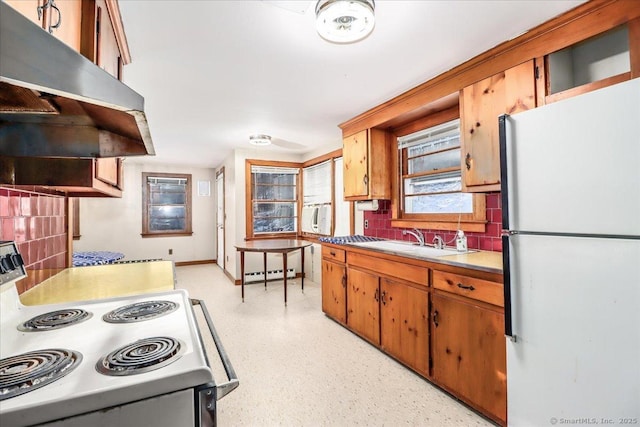 kitchen with tasteful backsplash, sink, white appliances, and baseboard heating