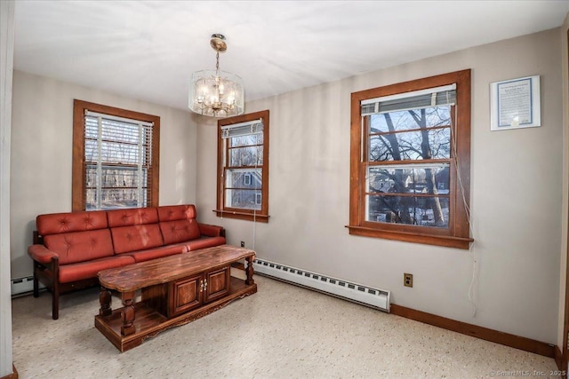 sitting room with an inviting chandelier, a baseboard radiator, and plenty of natural light