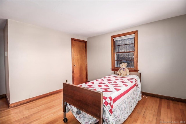 bedroom with hardwood / wood-style flooring