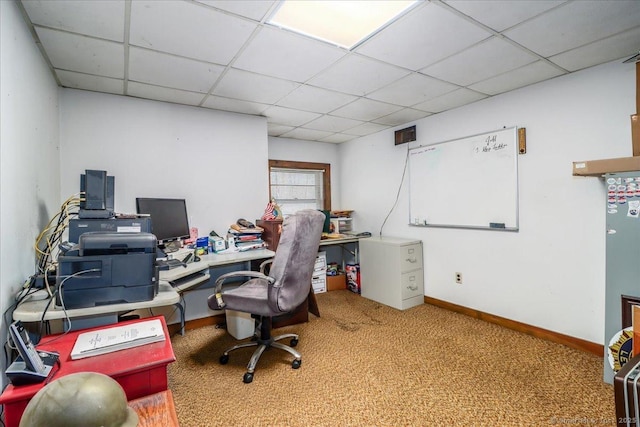 carpeted office with a paneled ceiling