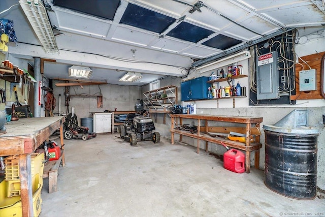 garage with a workshop area and electric panel