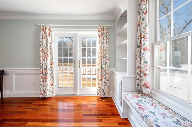 doorway featuring ornamental molding, dark hardwood / wood-style floors, and a wealth of natural light