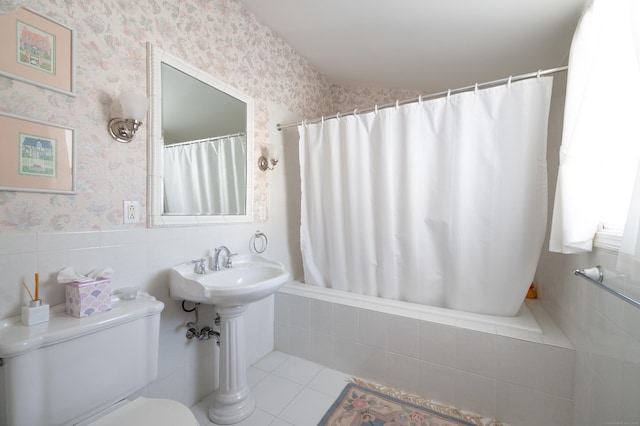 bathroom featuring tile patterned flooring, shower / bath combo, and toilet