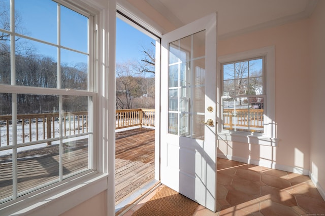 doorway to outside featuring a healthy amount of sunlight and tile patterned flooring