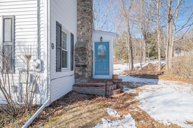 view of snow covered property entrance