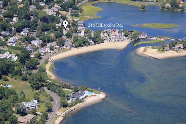 drone / aerial view featuring a water view and a beach view