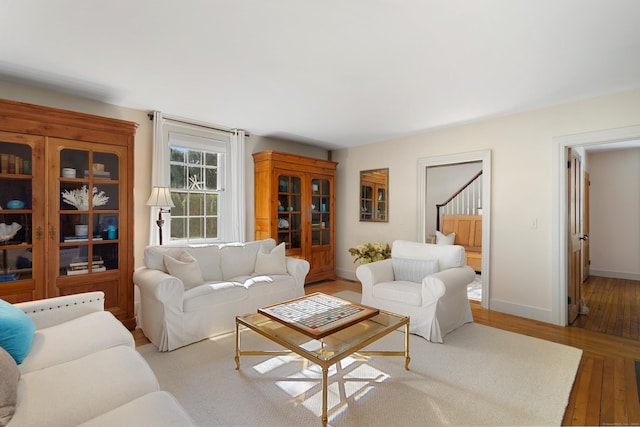 living room featuring wood finished floors and baseboards