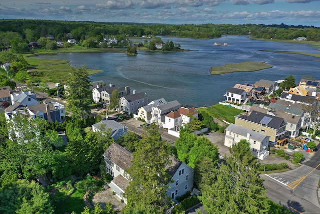 aerial view of property's location with a nearby body of water and nearby suburban area