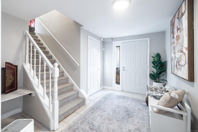 foyer entrance featuring light tile patterned flooring