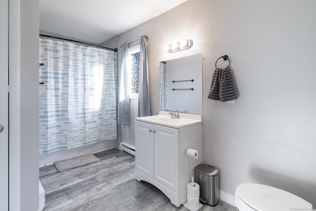 full bathroom with toilet, wood-type flooring, shower / tub combo, baseboard heating, and vanity