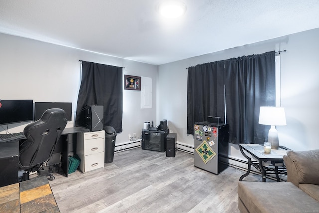 office area with baseboard heating and light wood-type flooring