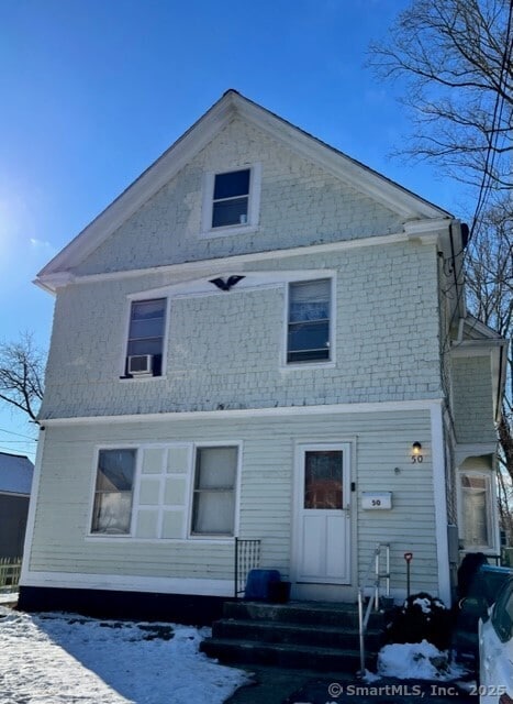 snow covered property with cooling unit