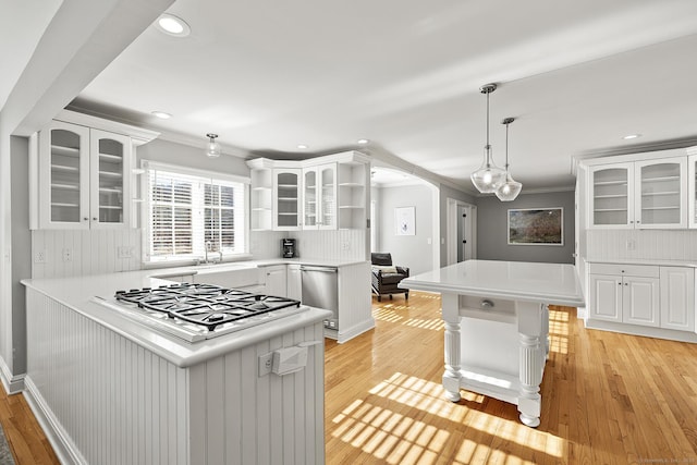 kitchen featuring white cabinetry, pendant lighting, backsplash, and kitchen peninsula