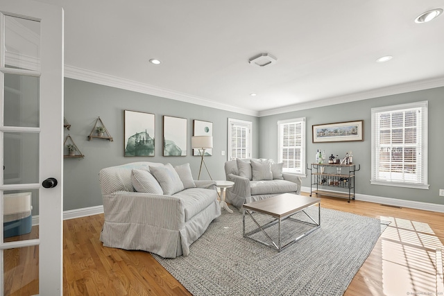 living room with crown molding and hardwood / wood-style flooring