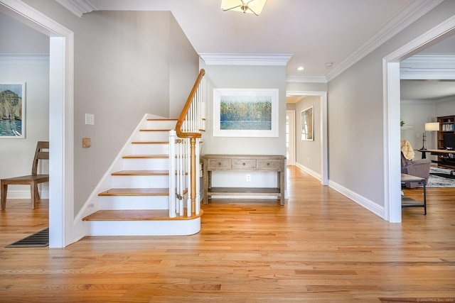 stairway featuring crown molding and hardwood / wood-style floors