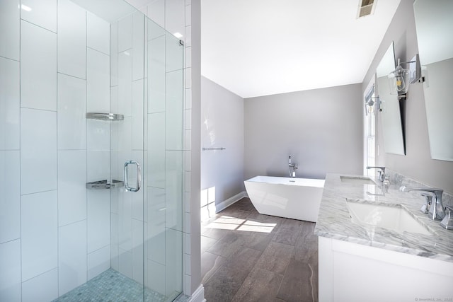 bathroom featuring vanity and separate shower and tub