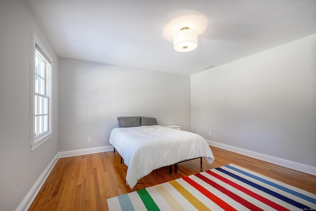 bedroom with hardwood / wood-style floors