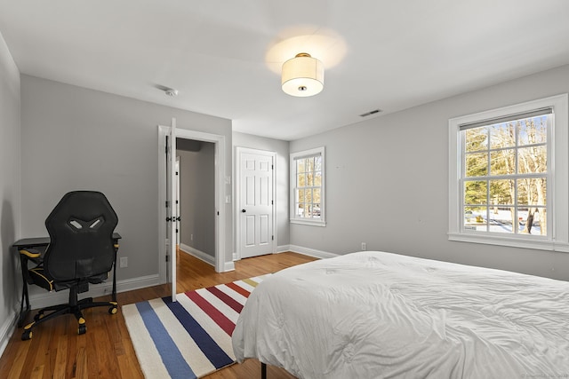 bedroom with wood-type flooring and a closet