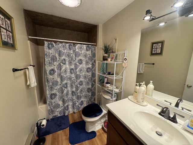 full bathroom with hardwood / wood-style floors, vanity, toilet, a textured ceiling, and shower / bath combo with shower curtain