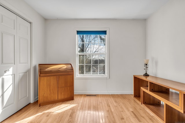 unfurnished room featuring a wealth of natural light and light hardwood / wood-style floors