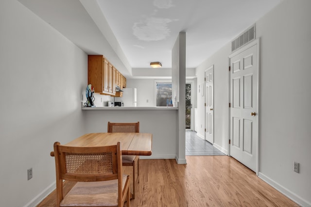 kitchen featuring light hardwood / wood-style floors and white fridge